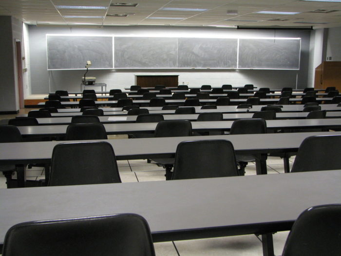 Lecture Rooms With Grey Tables & A Projector